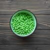 a bowl filled with peas on a table
