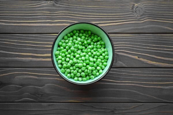 a bowl filled with peas on a table