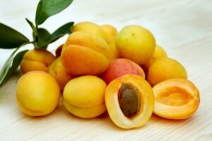 bunch of apricot and one of the is cutted