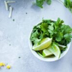 sliced lemon with coriander in a cup