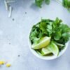sliced lemon with coriander in a cup